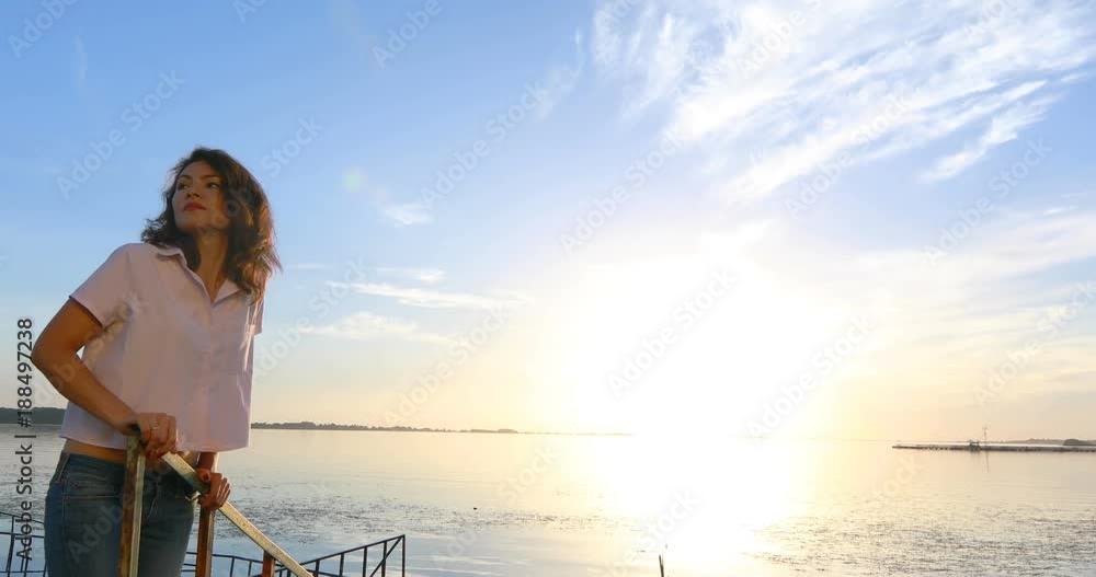 Woman at the pier by the river Woman at the pier by the river