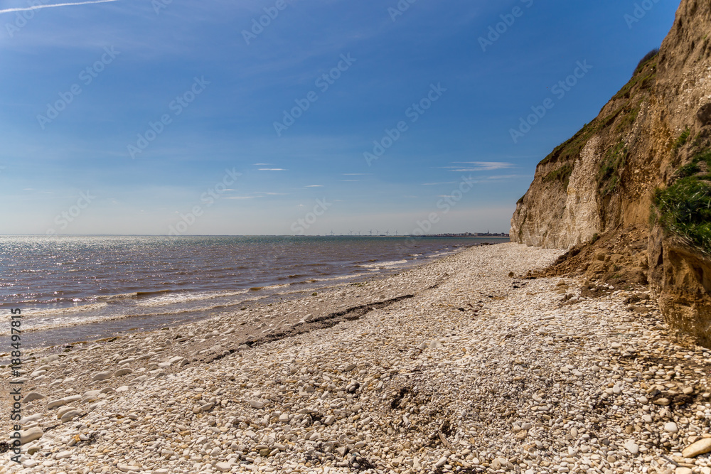 North sea coast with the pebble beach and cliffs of Danes Dyke near Bridlington, East Riding of Yorkshire, UK