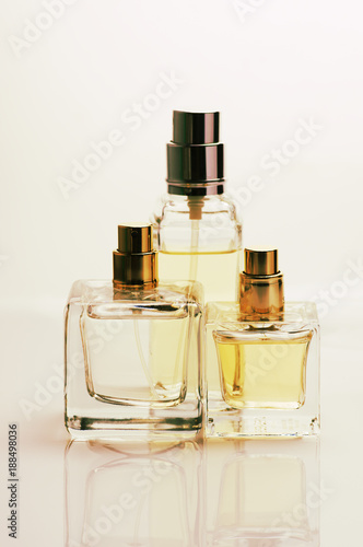 Three pastel colored perfume bottles