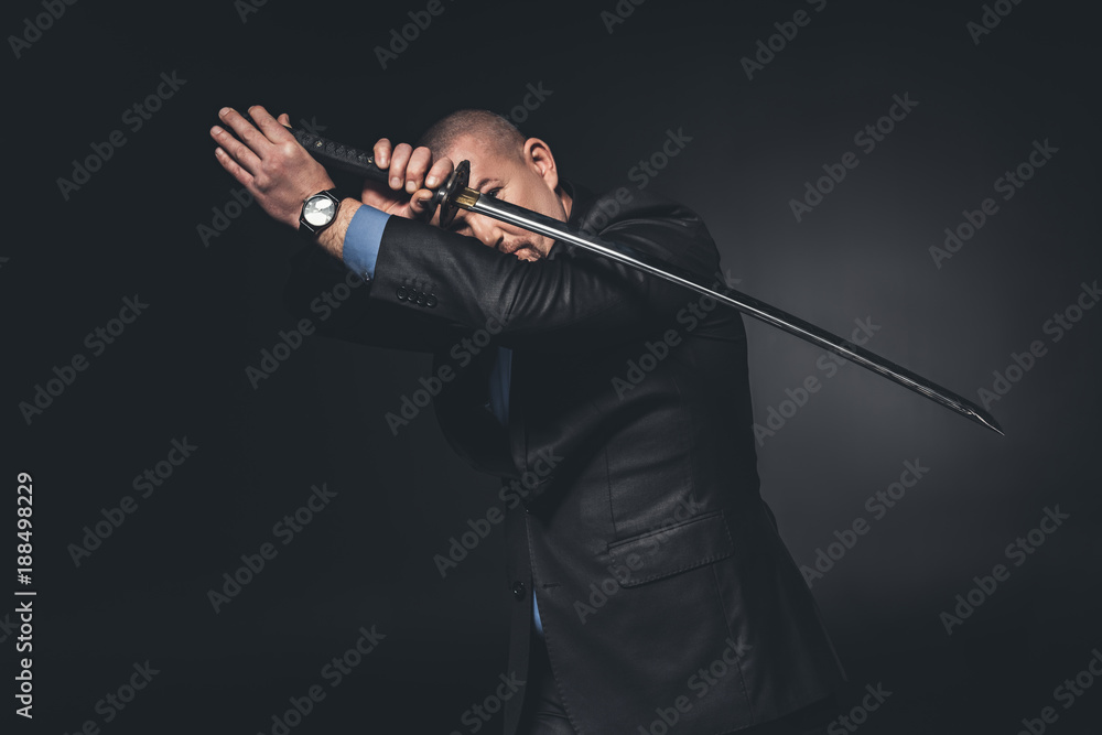 man in suit fighting with katana sword on black man in suit fighting with katana sword on black