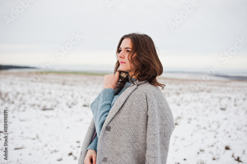 Gentle girl in gray coat against snow landscape. © AS Photo Family