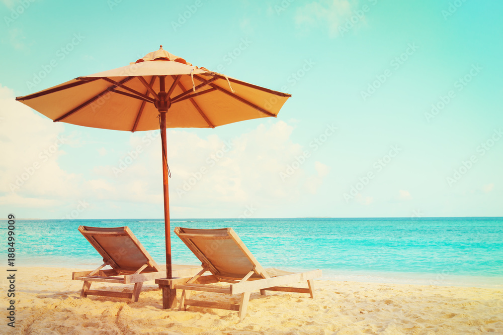 Fototapeta premium Two beach chairs on tropical vacation