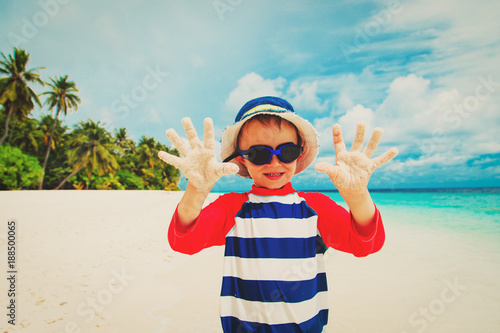 happy cute little boy on tropical beach