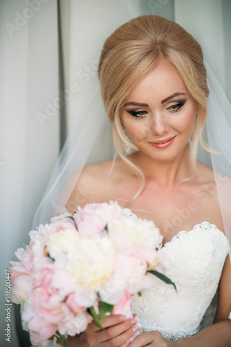 Beautiful bride in weddind dress posing to photographer