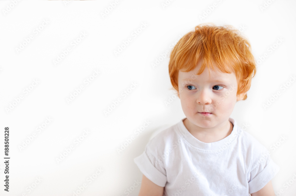 Pensive redhead boy on a white background Pensive redhead boy on a white background