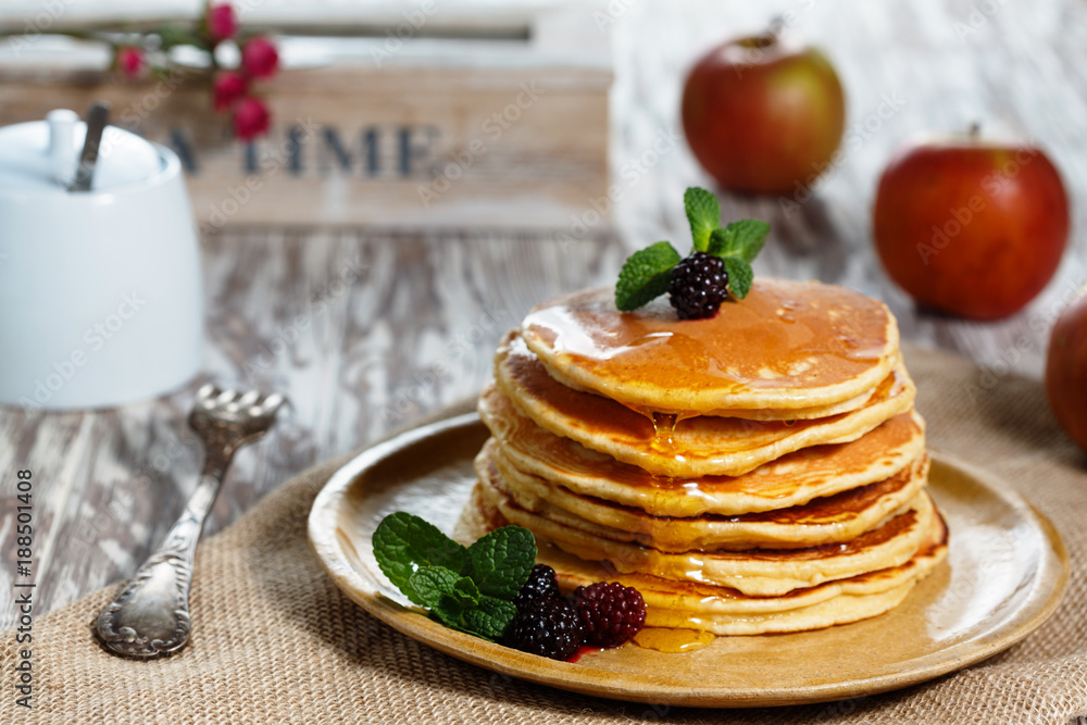 Homemade pancakes with honey and berry fruit. Closeup, selective focus.