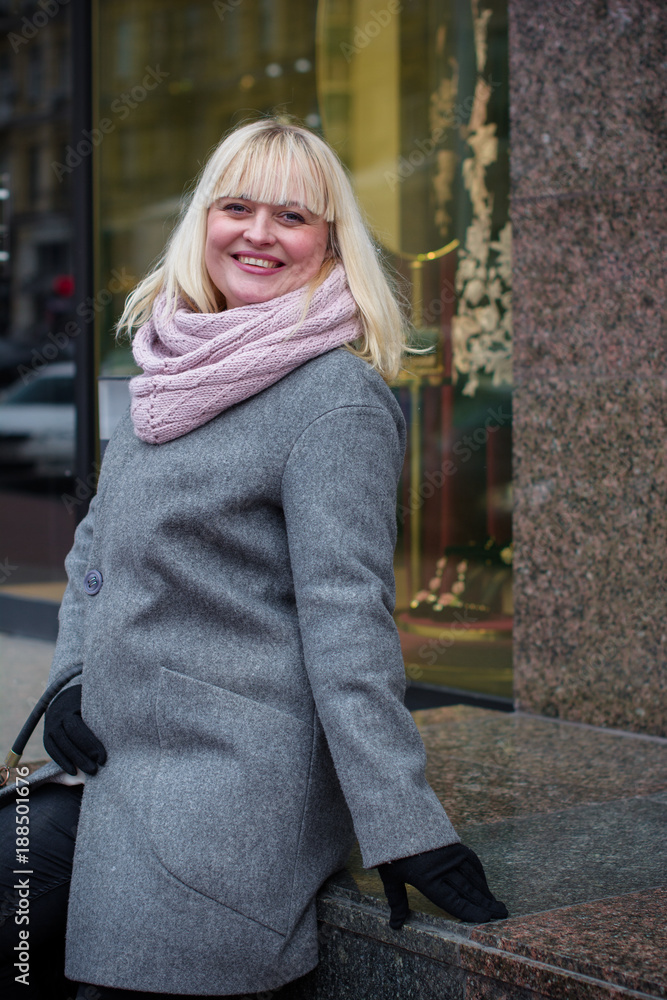 Fototapeta premium Nice middle-age plus size woman goes shopping for fashion, gift vouchers, shopping and enjoys. Black Friday, Cyber Monday and Boxing Day. Fashion accessories and casual clothes for women 