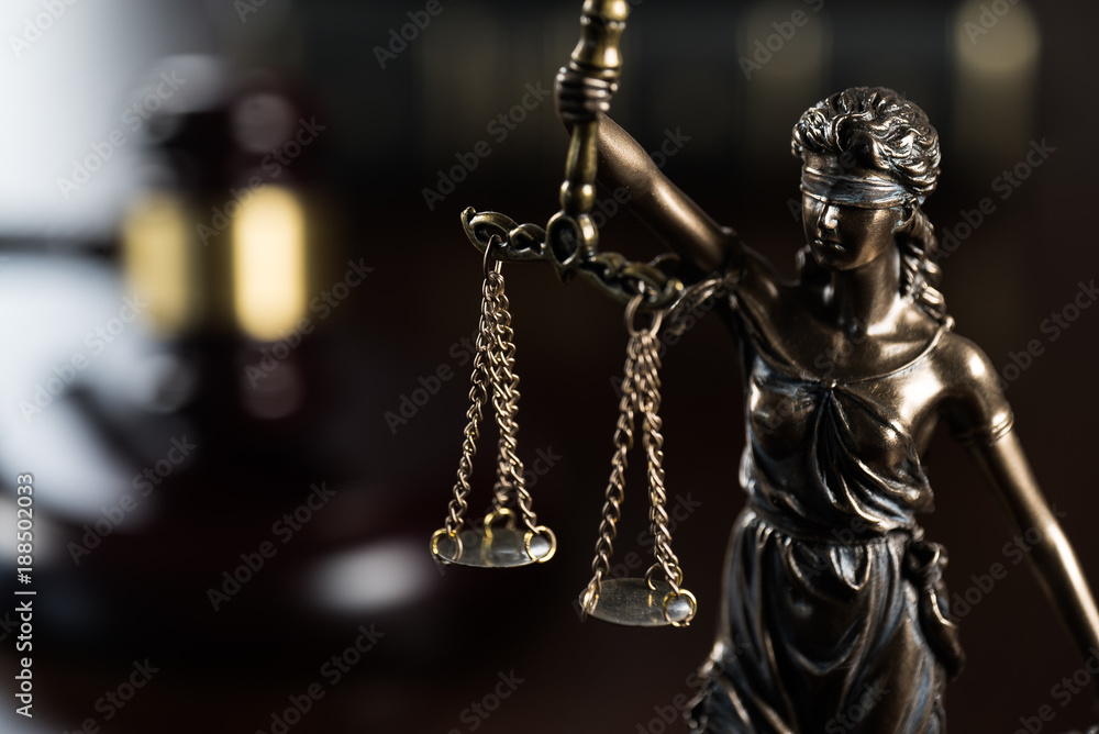 Law and Justice concept. Mallet of the judge, books, scales of justice. Gray stone background, reflections on the floor, place for typography. Courtroom theme.