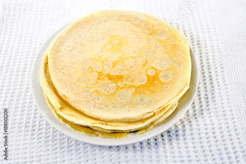 plate with pancakes on a white tablecloth