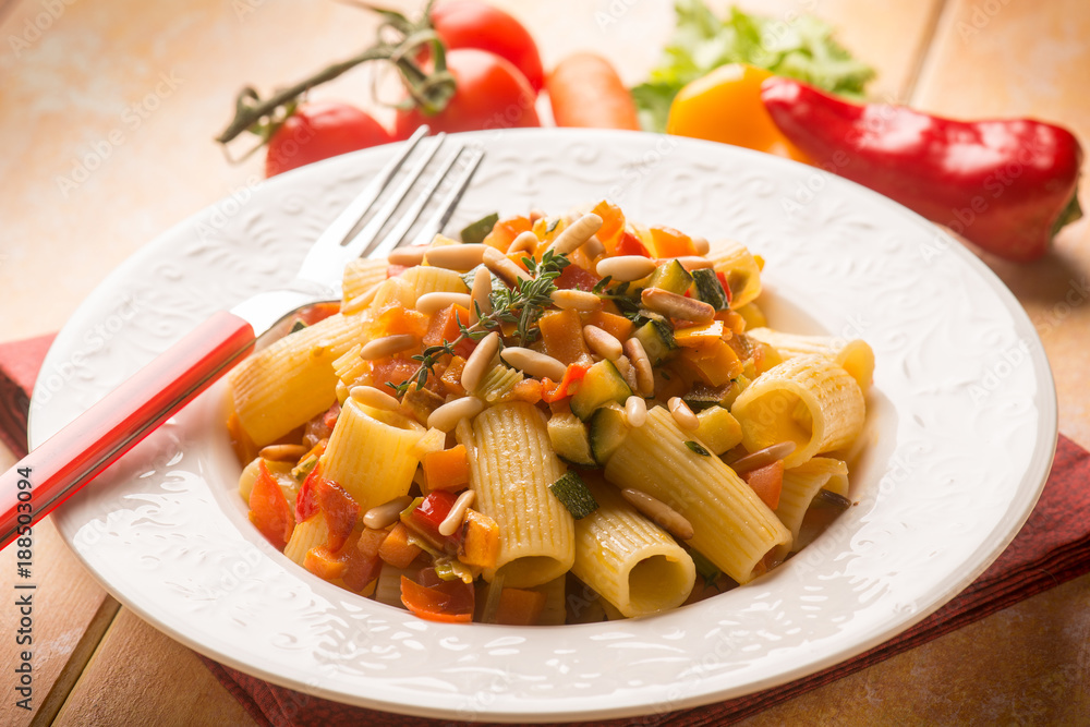 pasta with mixed vegetables and pine nuts, selective focus pasta with mixed vegetables and pine nuts, selective focus