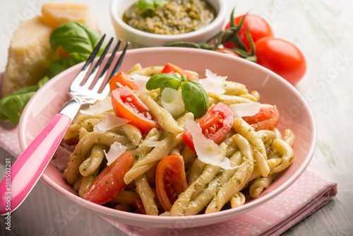 pasta with pesto  tomato e parmesan cheese flake, selective focus photo