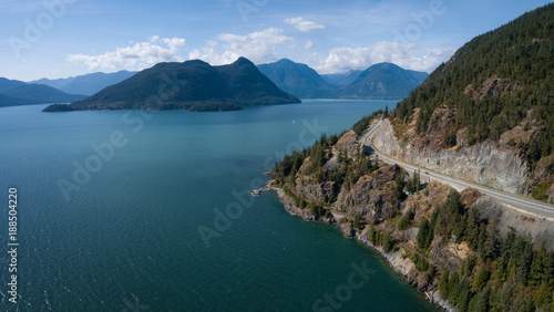 Aerial view of Sea to Sky Highway in Howe Sound during a vibrant sunny summer day. Taken North of Vancouver  BC  Canada.