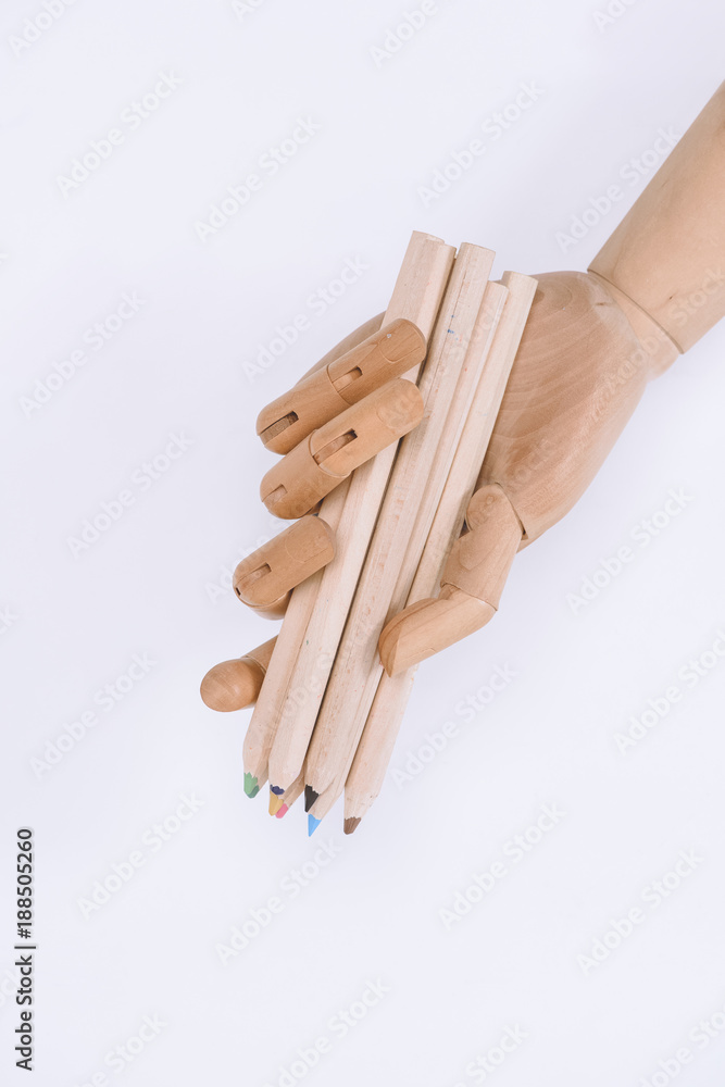 close-up view of mannequin holding colorful crayons isolated on white close-up view of mannequin holding colorful crayons isolated on white