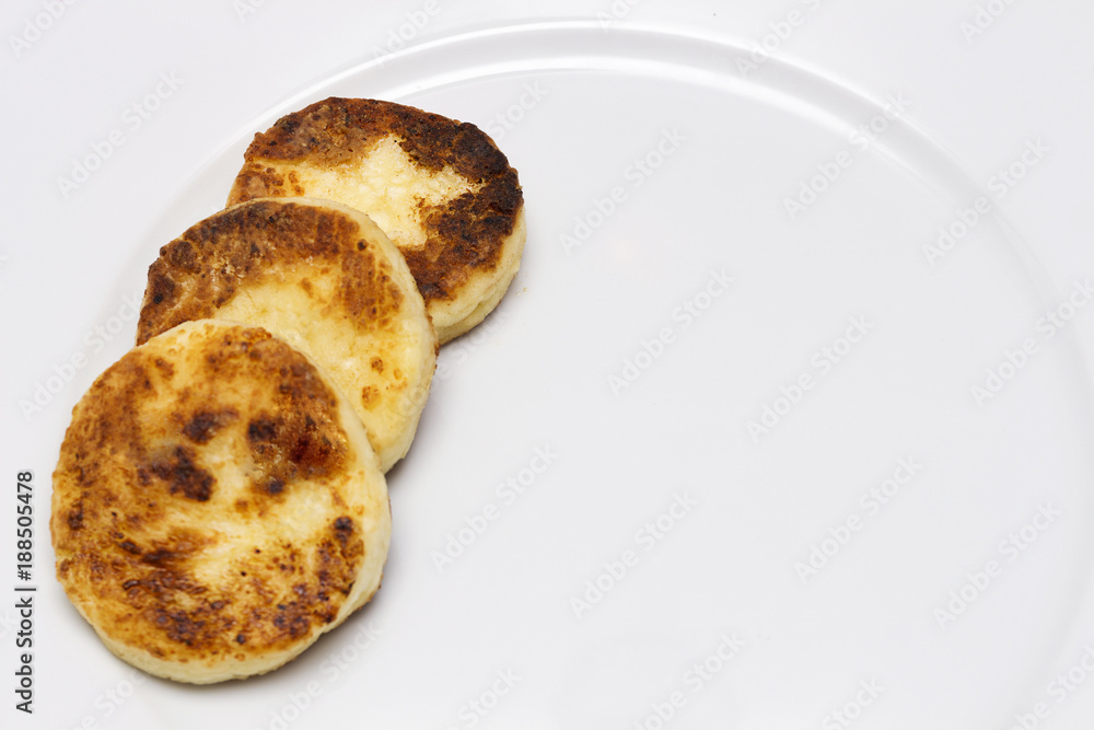 row of cheese pancakes on the white plate. Copy space row of cheese pancakes on the white plate. Copy space