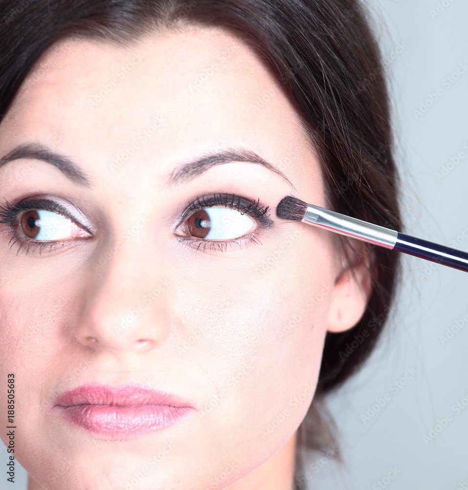 closeup . beautiful woman with brush for makeup