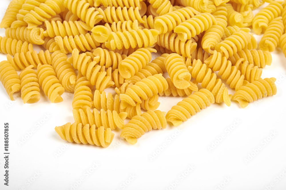 uncooked fusilli pasta noodles isolated on white background uncooked fusilli pasta noodles isolated on white background