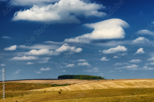 hilly field. a picturesque sky over a hilly field