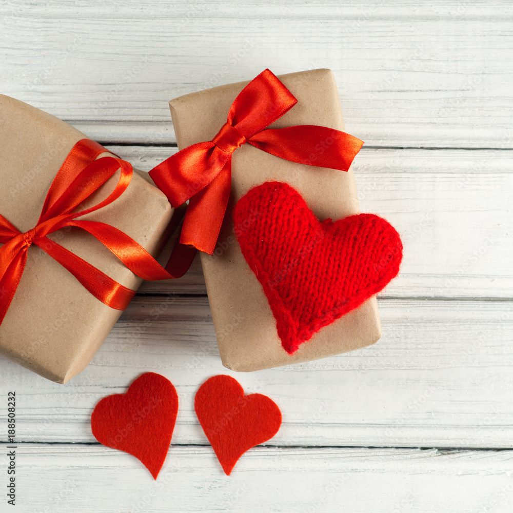 Valentine's Day concept. Gift with red bow on the wooden backgr