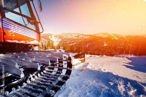 Snowcat trail bulldozer for skiers and snowboarders stands on background of mountains.Freeride snowboarding in Sheregesh ski resort photo