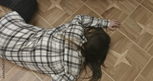 Unconscious or dead woman on floor.