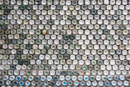 Bottle recycling: plastic bottles which have been set in concrete to form a bottle wall