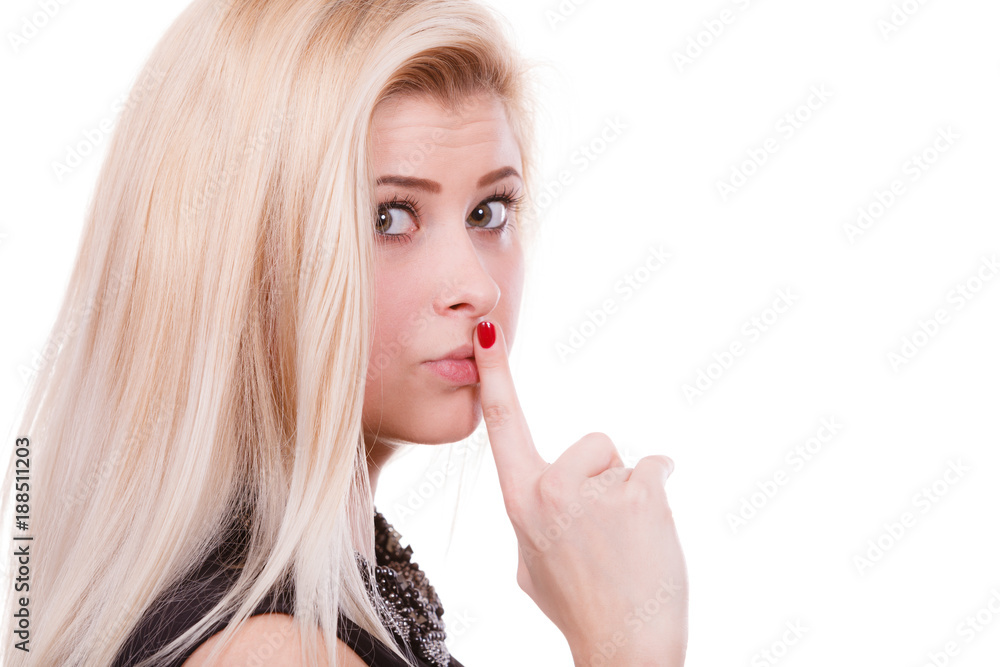 Attractive blonde woman making silence gesture