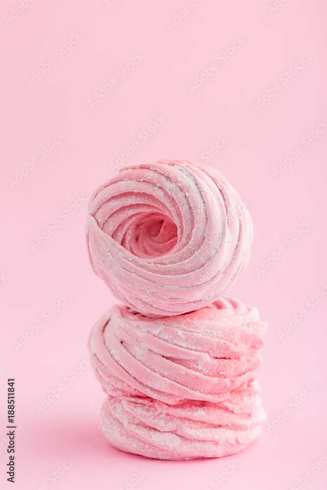 Homemade pink zephyr or marshmallow on pink background Homemade pink zephyr or marshmallow on pink background