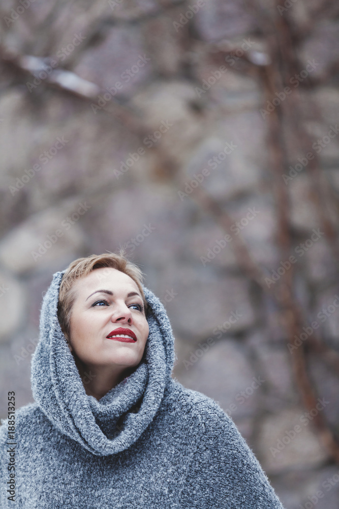 Portrait of beautiful woman in gray sweater Portrait of beautiful woman in gray sweater