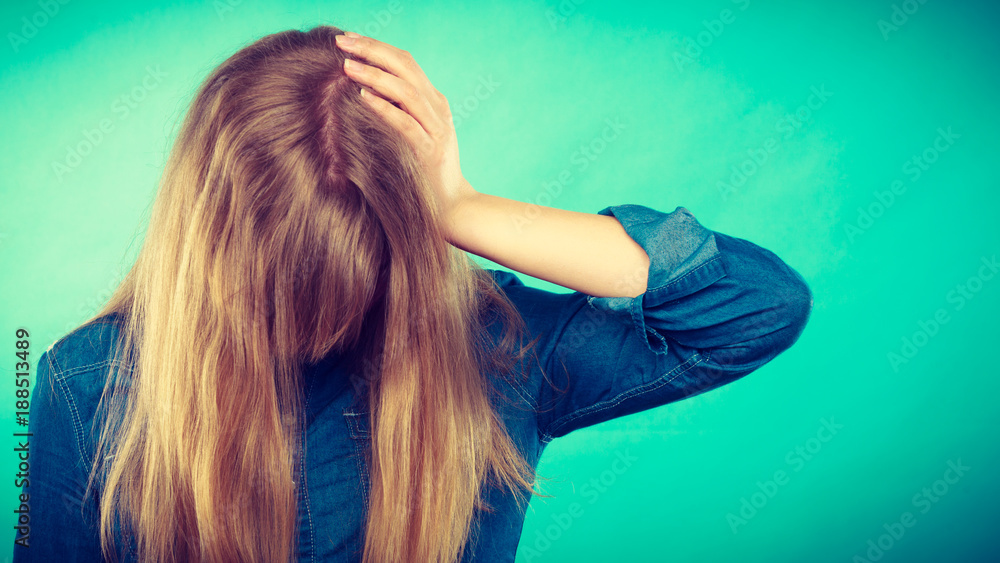 Depressed blonde woman covering face. Depressed blonde woman covering face.