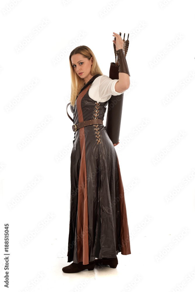 full length portrait of girl wearing brown fantasy costume, holding a bow and arrow. standing pose on white studio background. full length portrait of girl wearing brown fantasy costume, holding a bow and arrow. standing pose on white studio background.