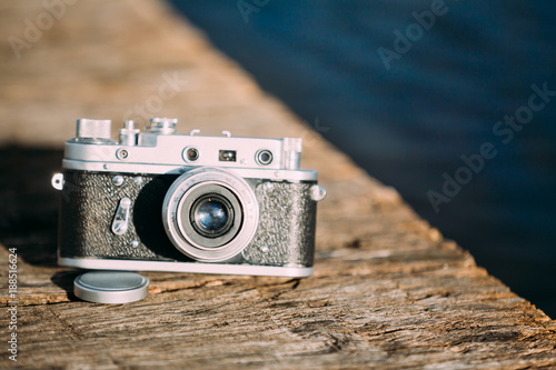 35mm Vintage Old Retro Small-Format Rangefinder Camera On Old Wooden