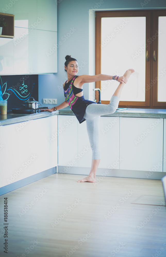 Fitness girl cooking healthy food in the kitchen. Woman. Kitchen. Cooking Fitness girl cooking healthy food in the kitchen. Woman. Kitchen. Cooking
