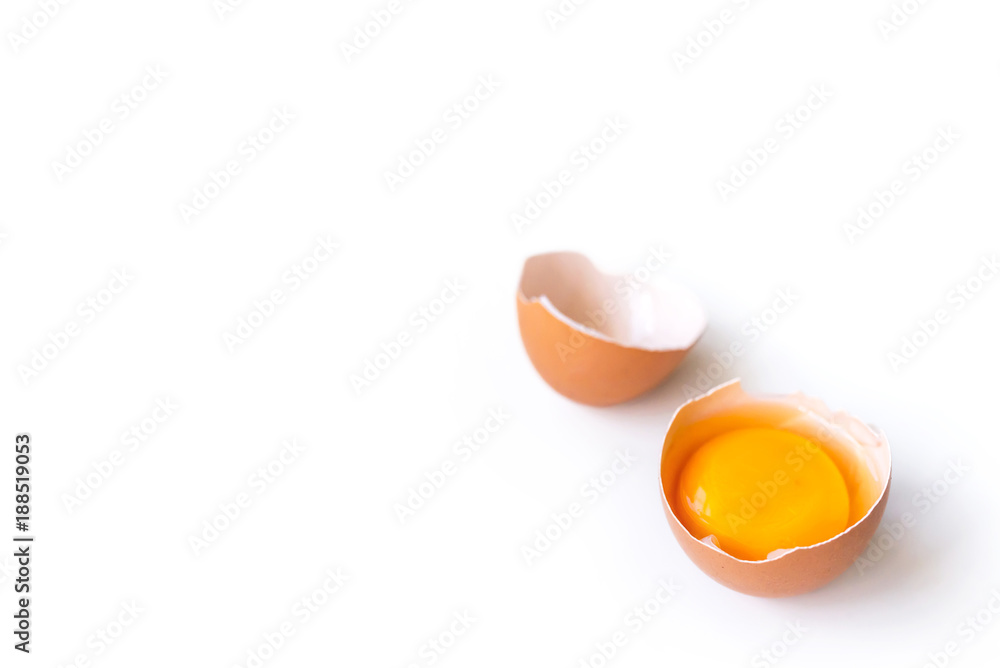 fresh brown organic chicken egg broken with yolk and egg white isolated on white background. Horizontal composition. fresh brown organic chicken egg broken with yolk and egg white isolated on white background. Horizontal composition.