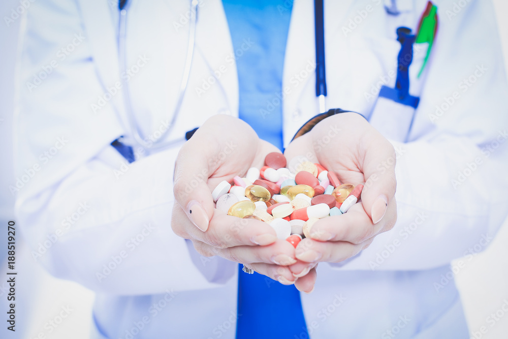 Doctor holding heap of drugs in a hand. Woman doctor Doctor holding heap of drugs in a hand. Woman doctor