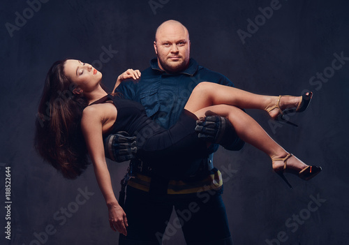 Fireman holds saved woman.