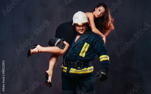 Firefighter holds a woman.