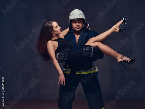 Fireman holds saved woman.