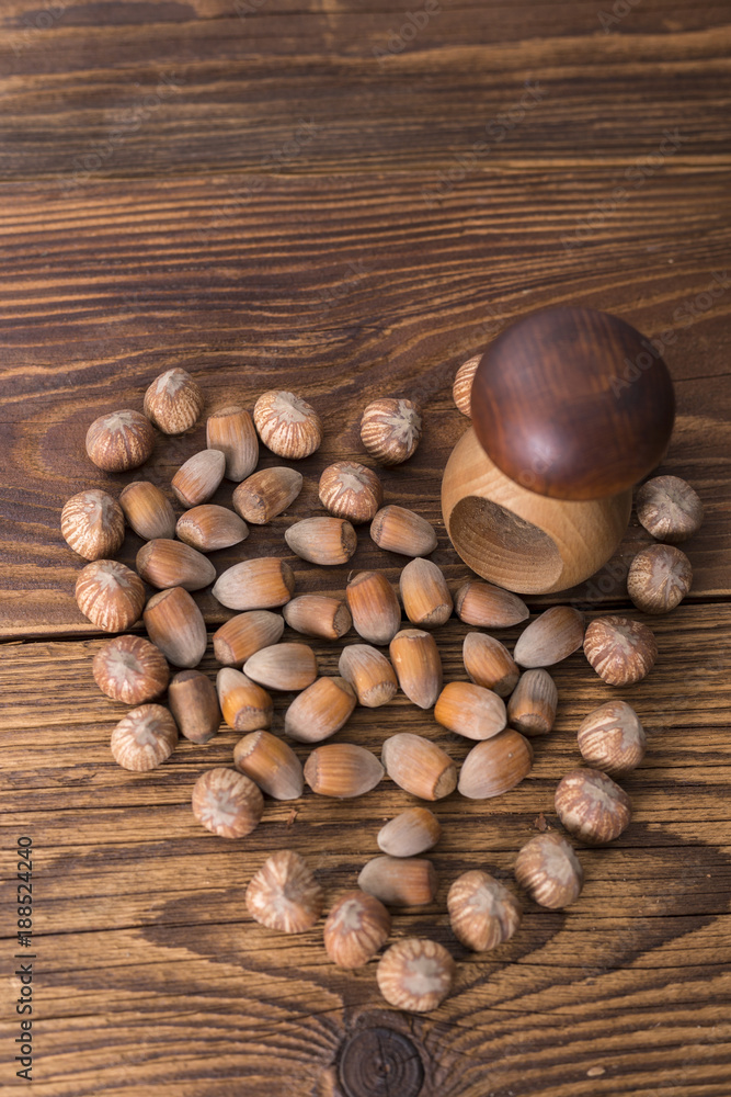 .hazelnuts and nutcracker on a wooden background .hazelnuts and nutcracker on a wooden background