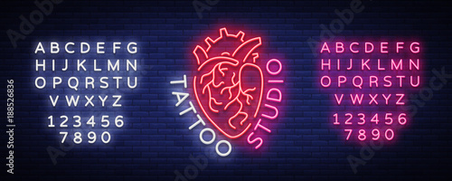 Tattoo studio logo, neon sign, symbol of human heart, bright billboards, night banner, neon bright advertising on tattoos, for tattoo salon, studio. Vector illustration. Editing text neon sign