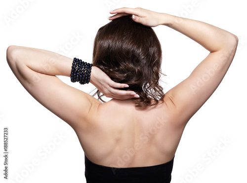 Brunette woman from backside on gray background