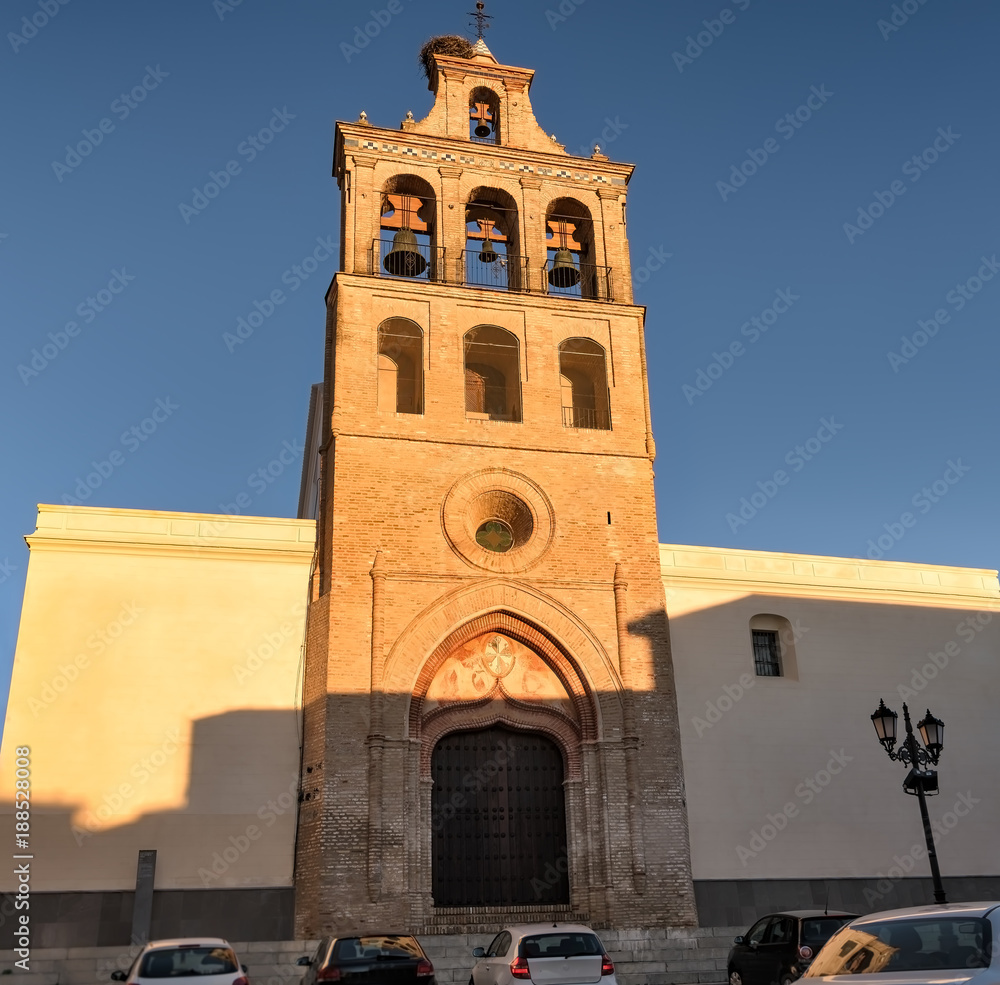 Facade and bell tower in the  church of Lepe, a white village in Andalusia, Spain.
