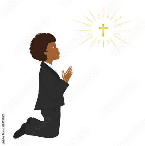 African american boy praying on knees on his first holy communion day.
