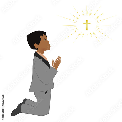 Small latin boy praying on knees. First communion sacrament.
