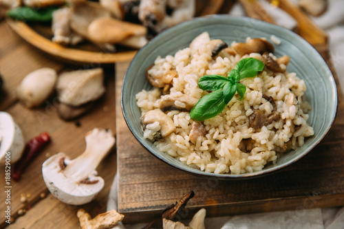 Risotto with mushrooms on an old wooden background. Rustic style. photo