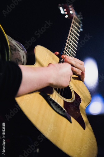 Acoustic guitarist performing on stage during concert