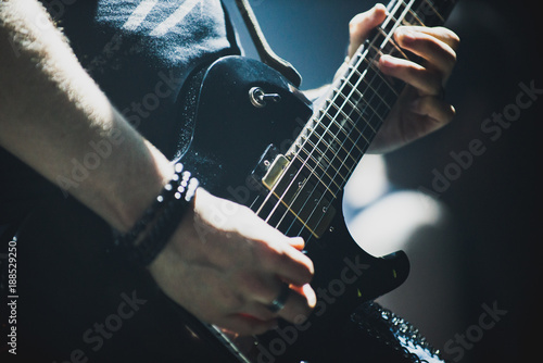 Fotografiet Close up of lead guitarist performing a solo on stage during concert
