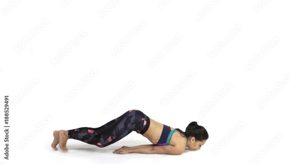 Young attractive woman practicing yoga doing Shalabhasana, the Locust pose in full length, isolated over white studio background Young attractive woman practicing yoga doing Shalabhasana, the Locust pose in full length, isolated over white studio background