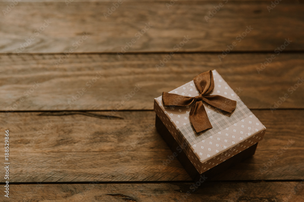 gift box with bow on wooden background gift box with bow on wooden background