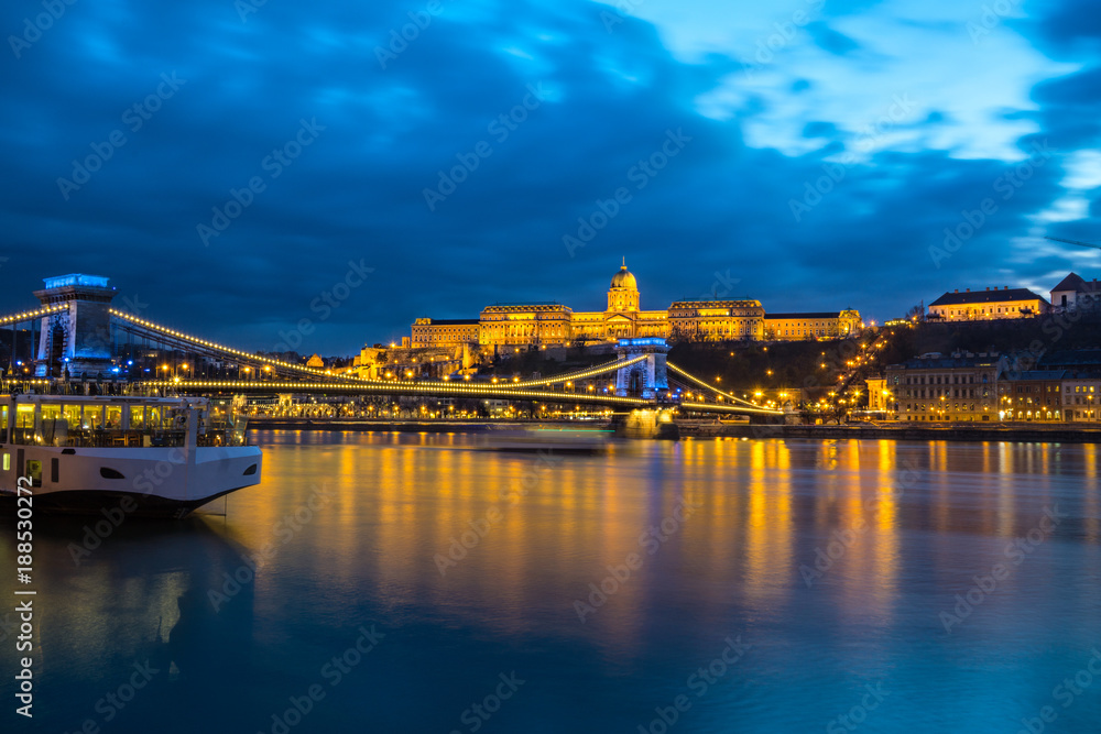 Illuminated building of Buda Castle and Chain bridge at night in  Budapest.