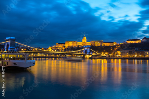 Illuminated building of Buda Castle and Chain bridge at night in Budapest.